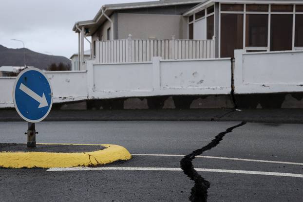 Cracks emerge on a road due to volcanic activity near a police station, in Grindavik