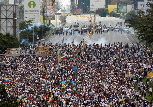 Demonstrators clash with riot police during the so-called "mother of all marches" against Venezuela