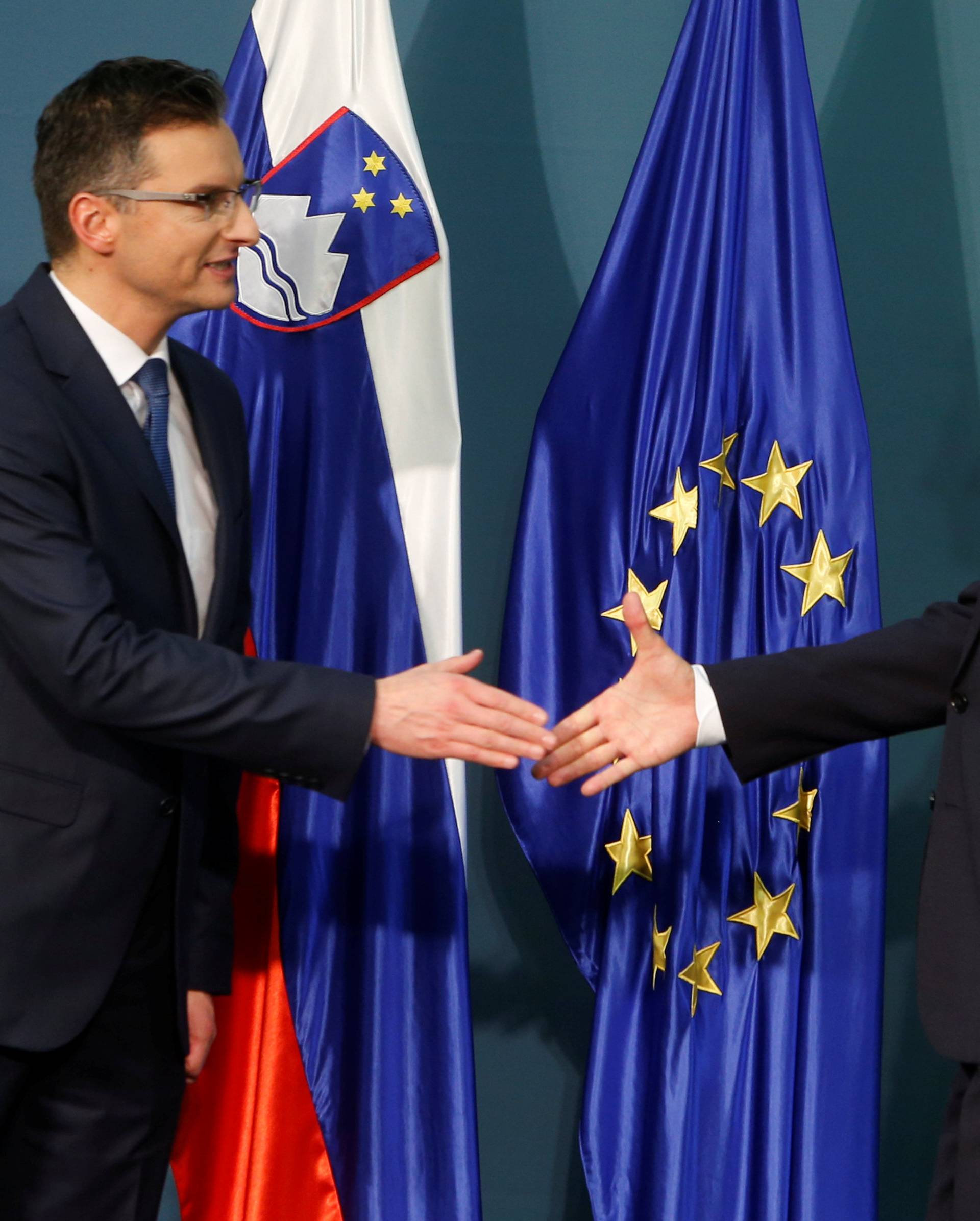 Presidential candidates Borut Pahor and Marjan Sarecreacts shake hands after first results of the second round of the presidential elections in Ljubljana