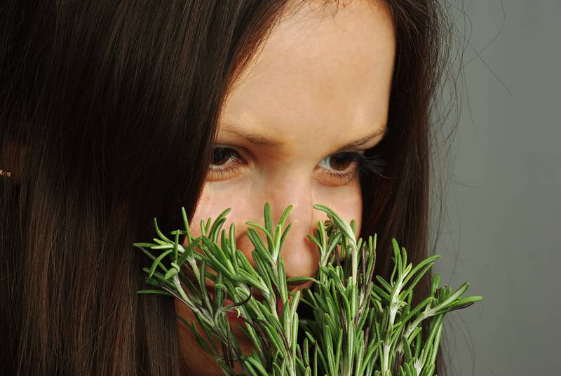 Girl sniffing rosemary