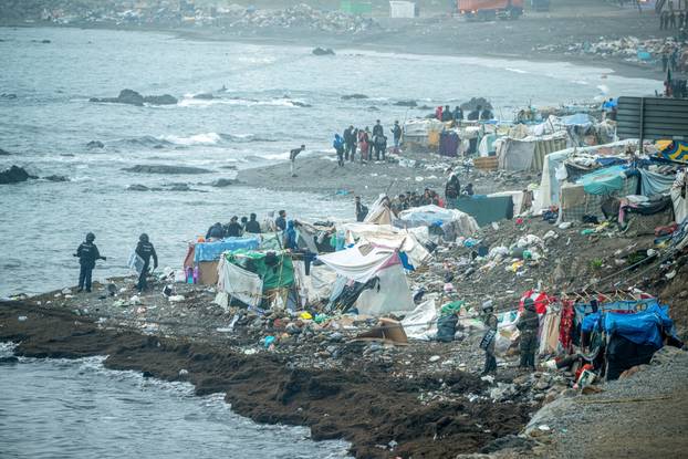 Spanish police clear an encampment of migrants at El Trampolin beach in the Spanish enclave of Ceuta