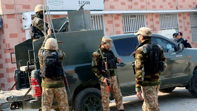 Security personnel stand guard outside a hospital, in Dera Ismail Khan