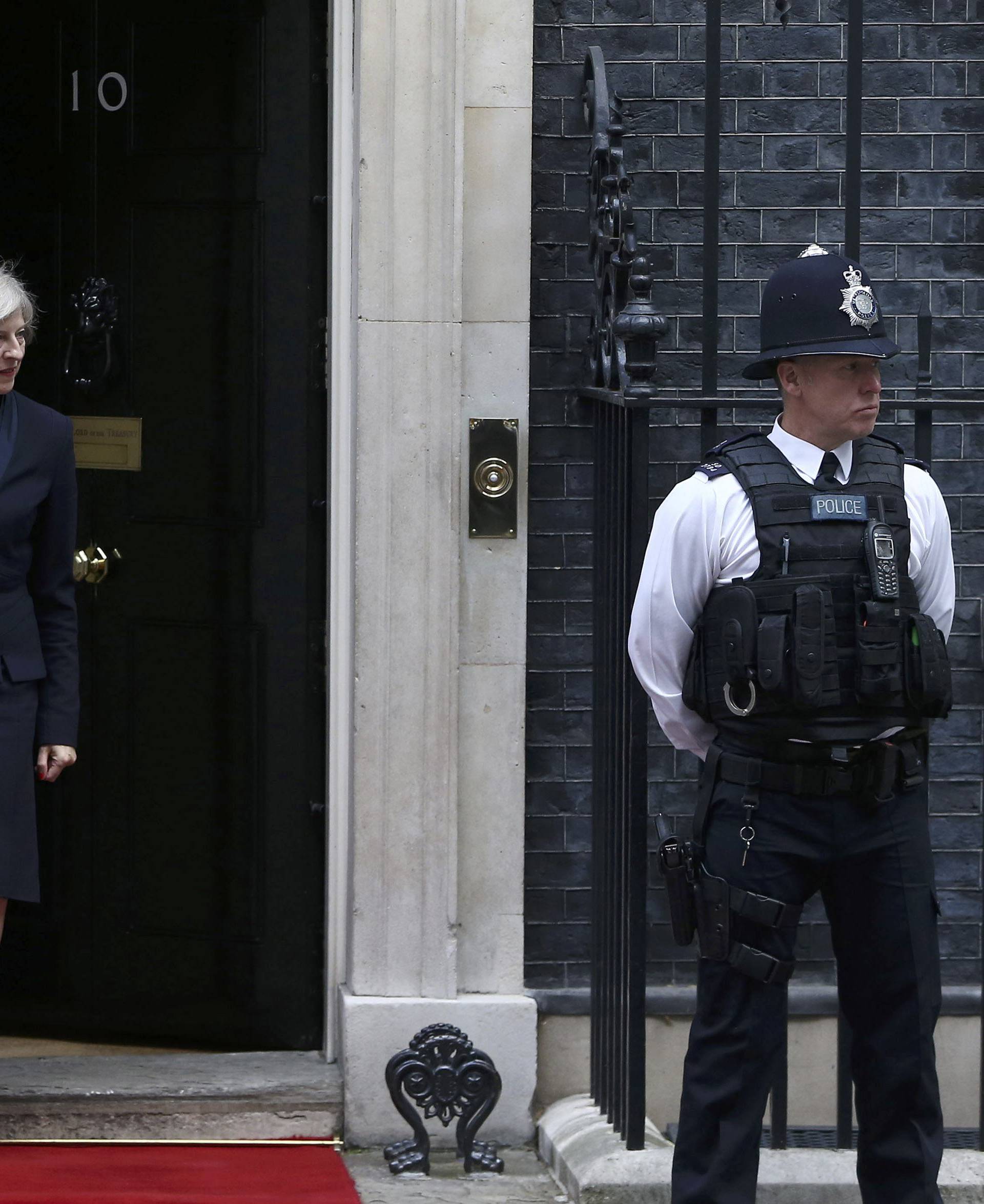 Britain's Prime Minister Theresa May (L) waits to greets Croatia's President Kolinda Grabar-Kitarovic at Downing Street in London