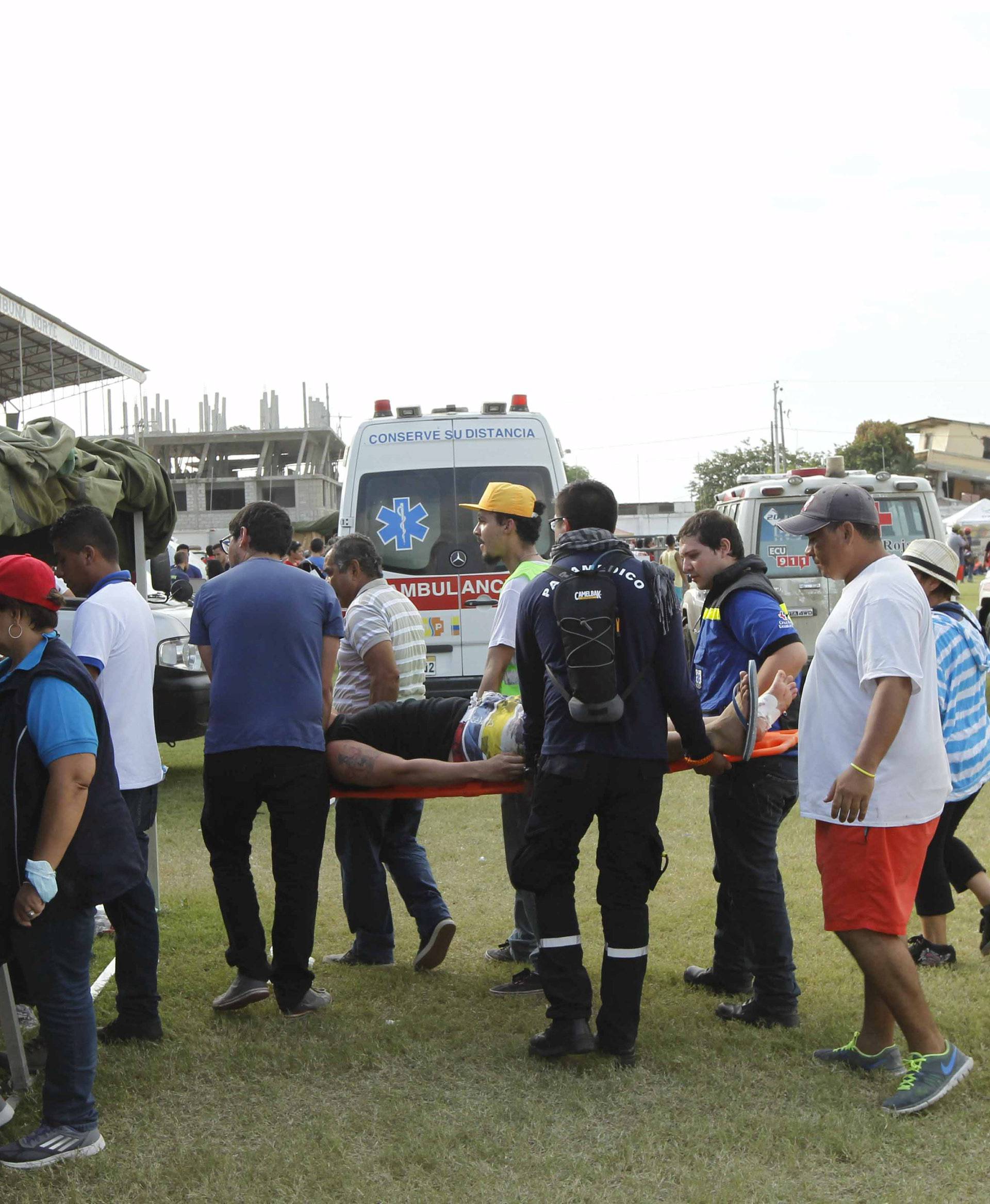 An injured person is attended to at the Maximino Puertas stadium as rescue efforts continue in Pedernales, after an earthquake struck off Ecuador's Pacific coast
