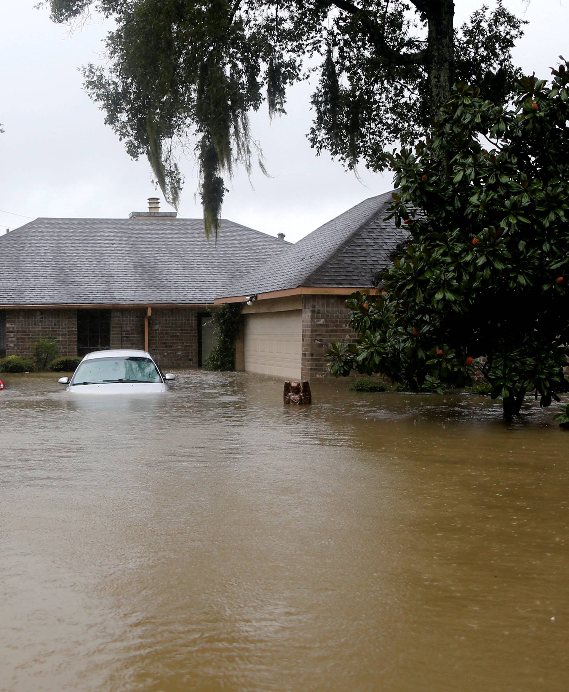 Houses and cars are seen partially submerged by flood waters from tropical storm Harvey in east Houston