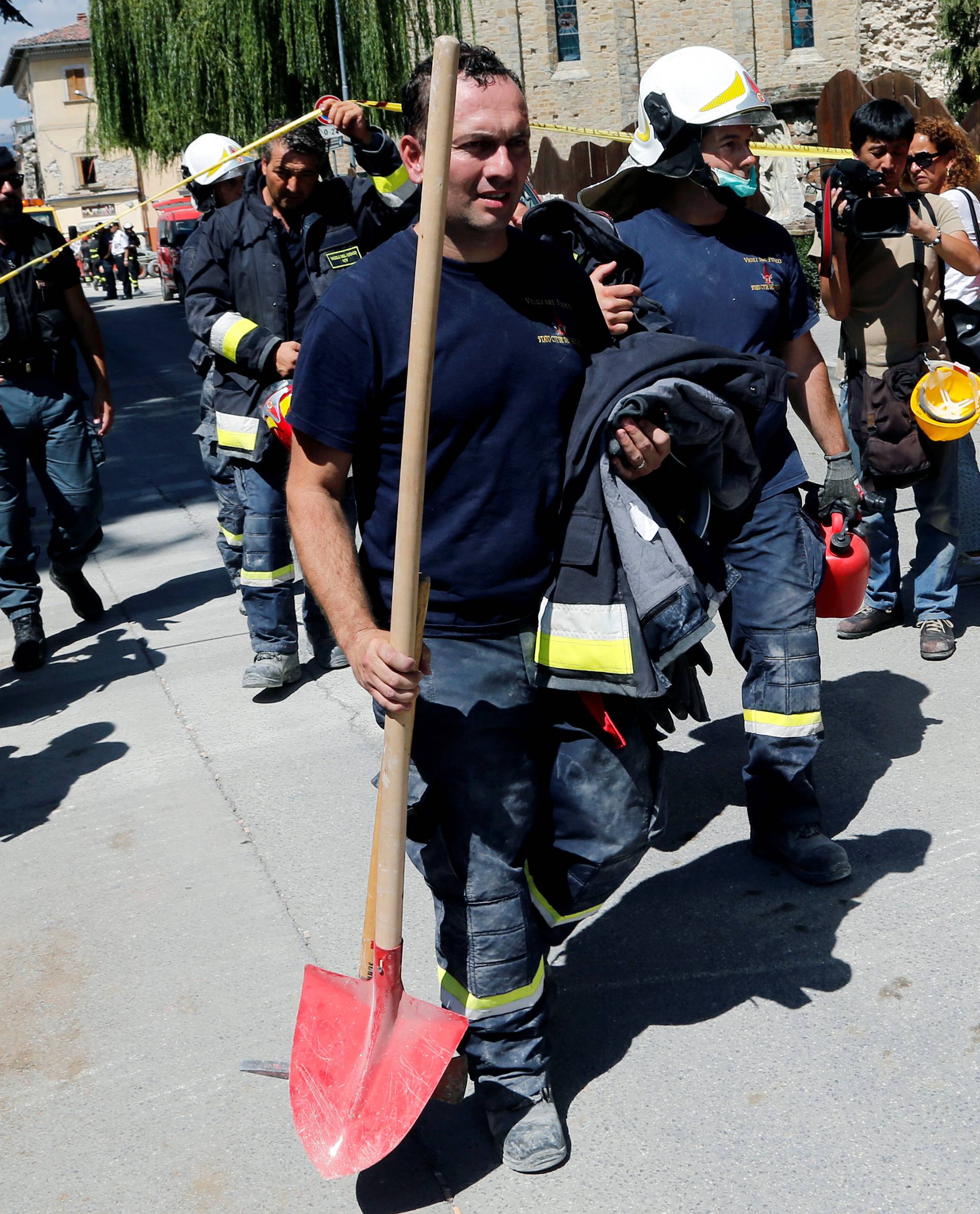 Firefighters of Vatican City leave the damaged areas following an earthquake in Amatrice