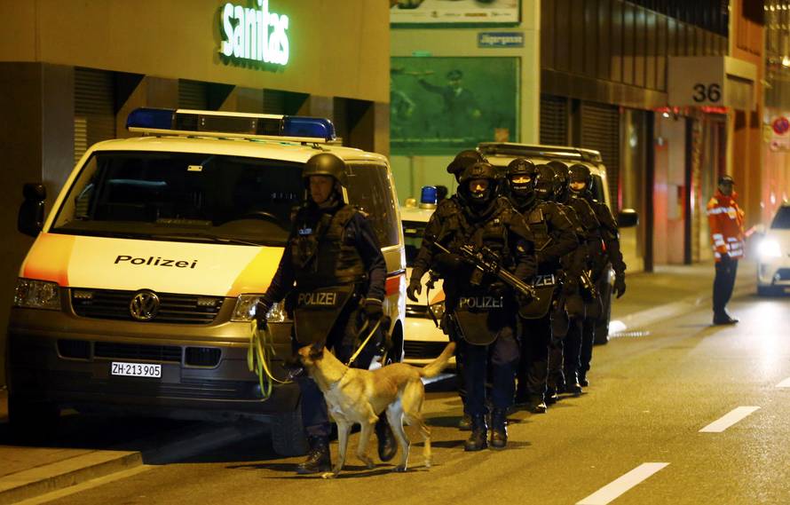 Police stand outside an Islamic center in central Zurich