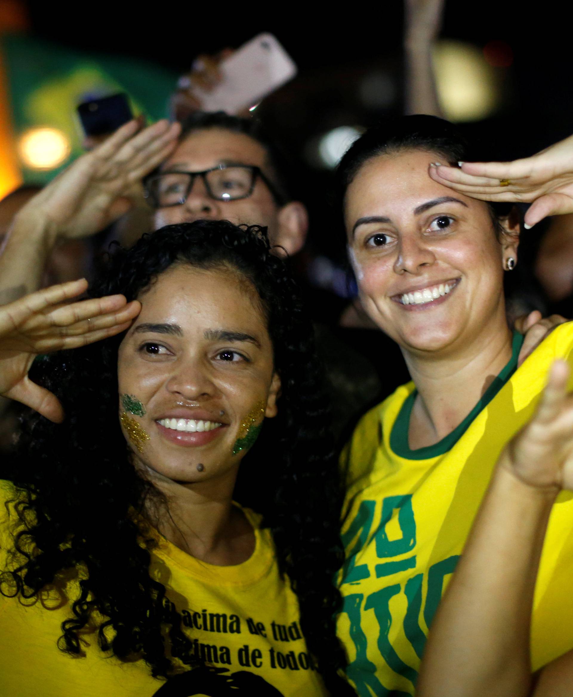 Supporters of Jair Bolsonaro react after Bolsonaro won the presidential race, in Brasilia