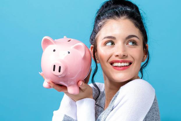 Young woman with a piggy bank