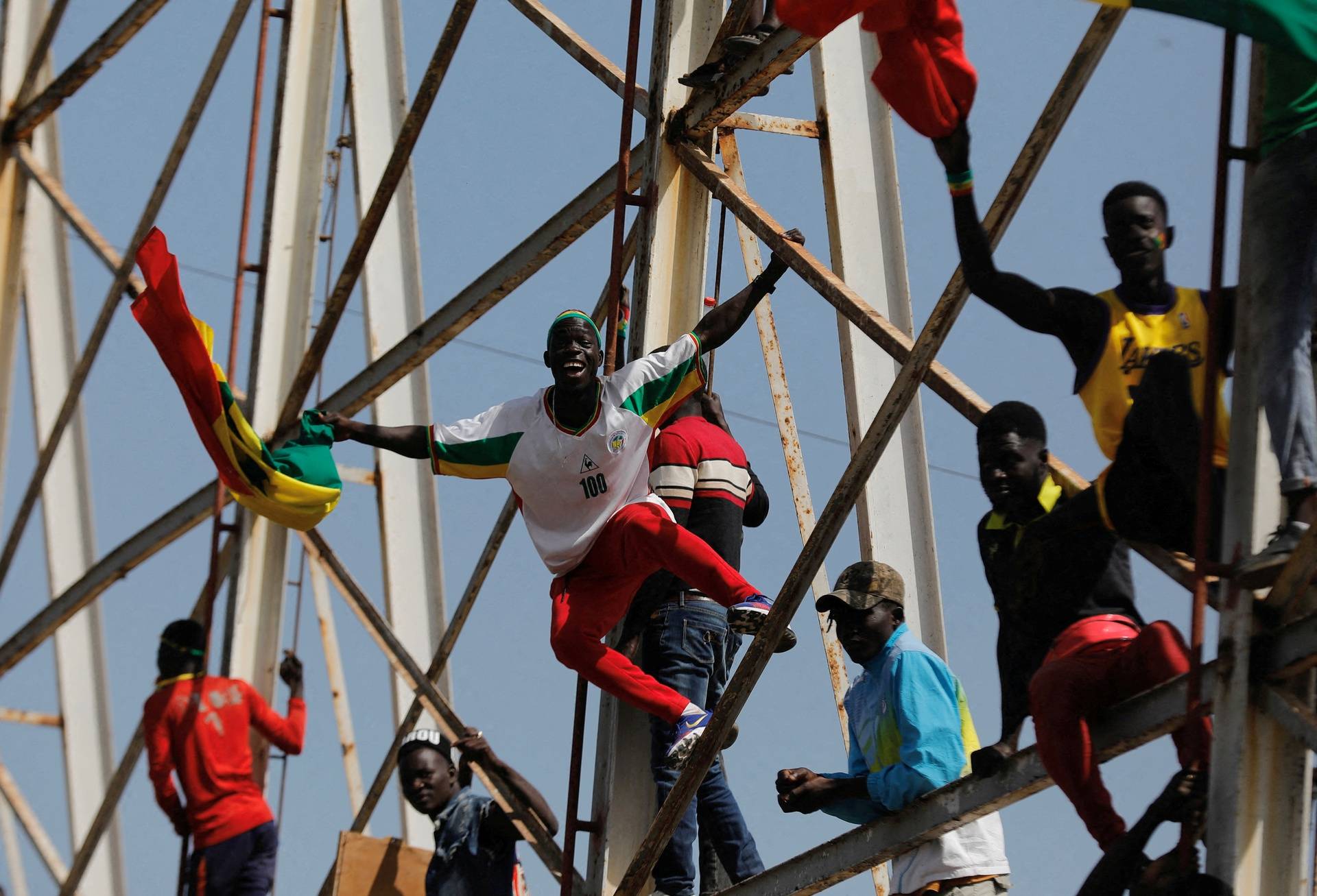 Senegalese fans celebrate as they wait to welcome the Senegal National Soccer Team after their Africa Cup win, in Dakar