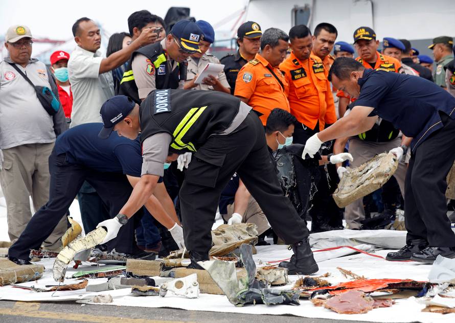 Rescue workers lay out newly recovered debris of Lion Air flight JT610 at Tanjung Priok port in Jakarta