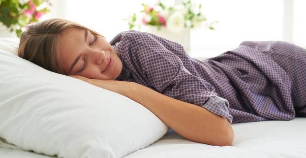 Close-up of beautiful woman in satin pajamas sleeping peacefully