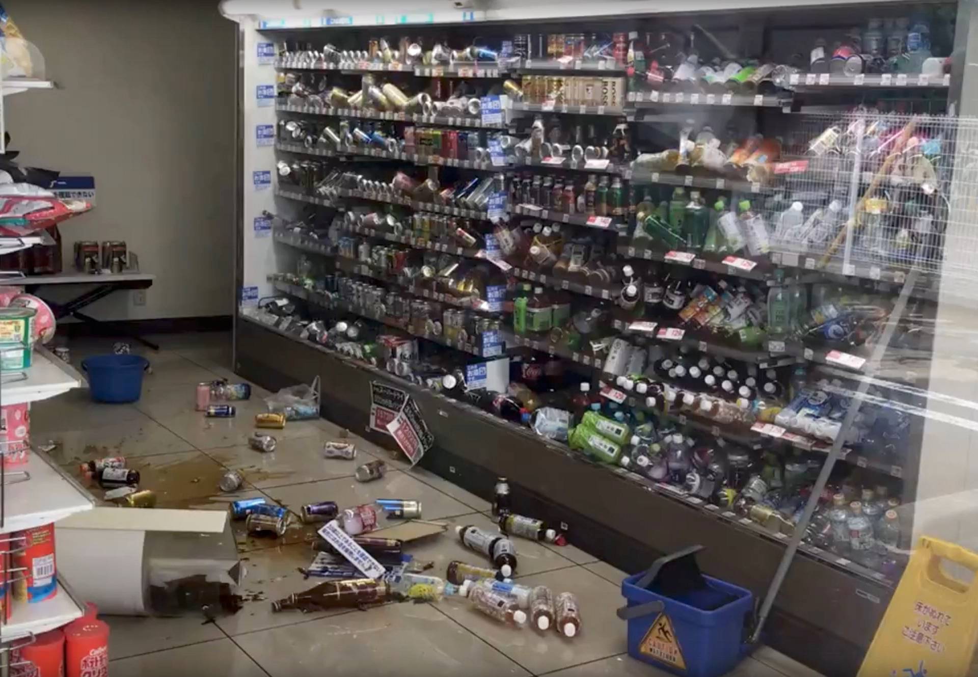 Bottled drinks are scattered on the floor of a shop after an earthquake hit Osaka