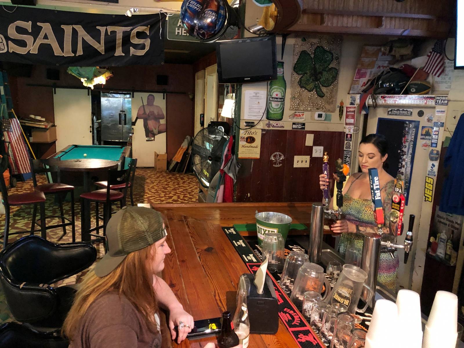 New Orleans resident Miranda Duchesne chats with the bartender at Traceyâs ahead of Tropical Storm Barryâs forecast arrival in New Orleans