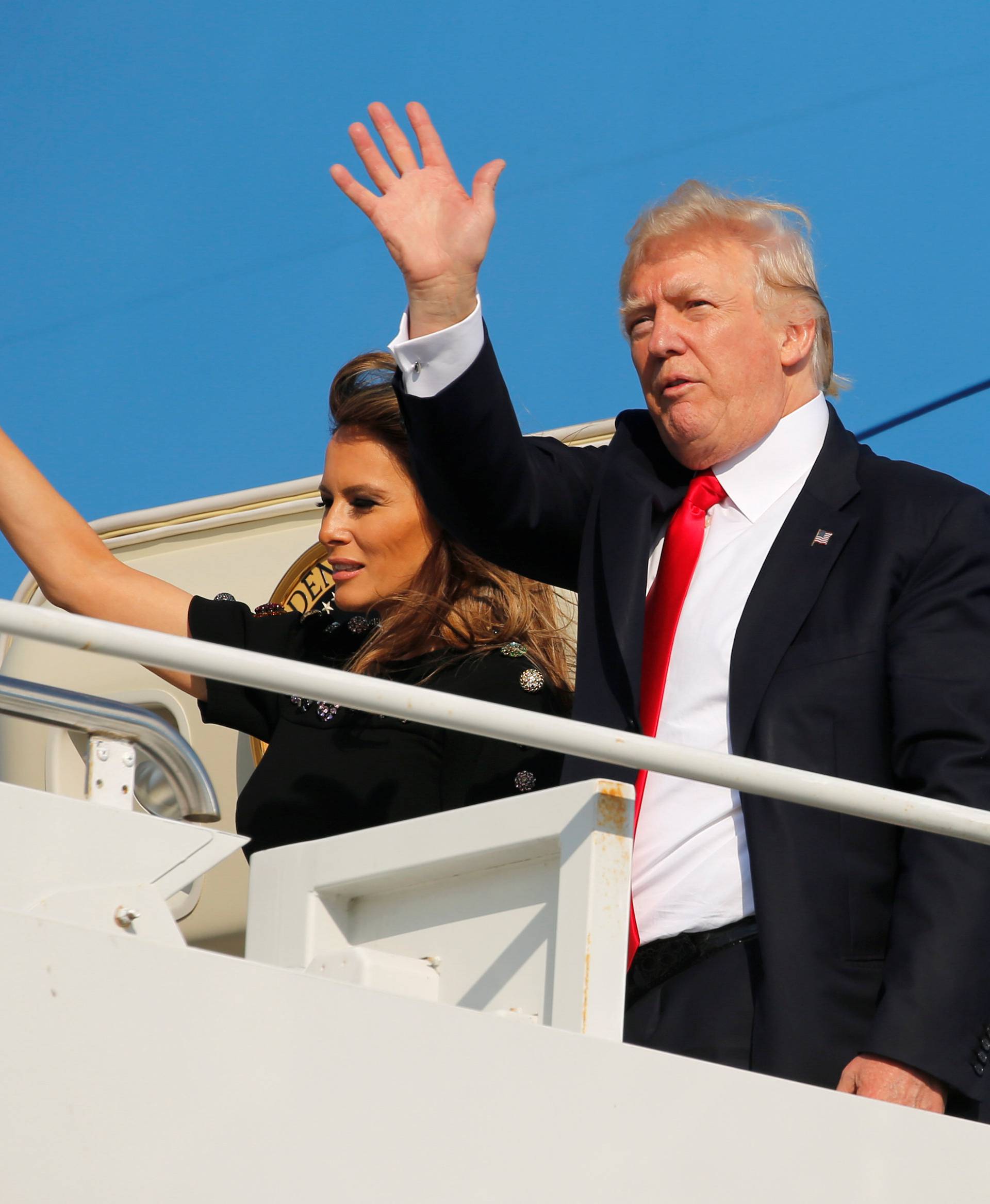 U.S. President Trump and first lady Melania Trump wave outside Air Force One before returning to Washington D.C. at Sigonella Air Force Base in Sigonella