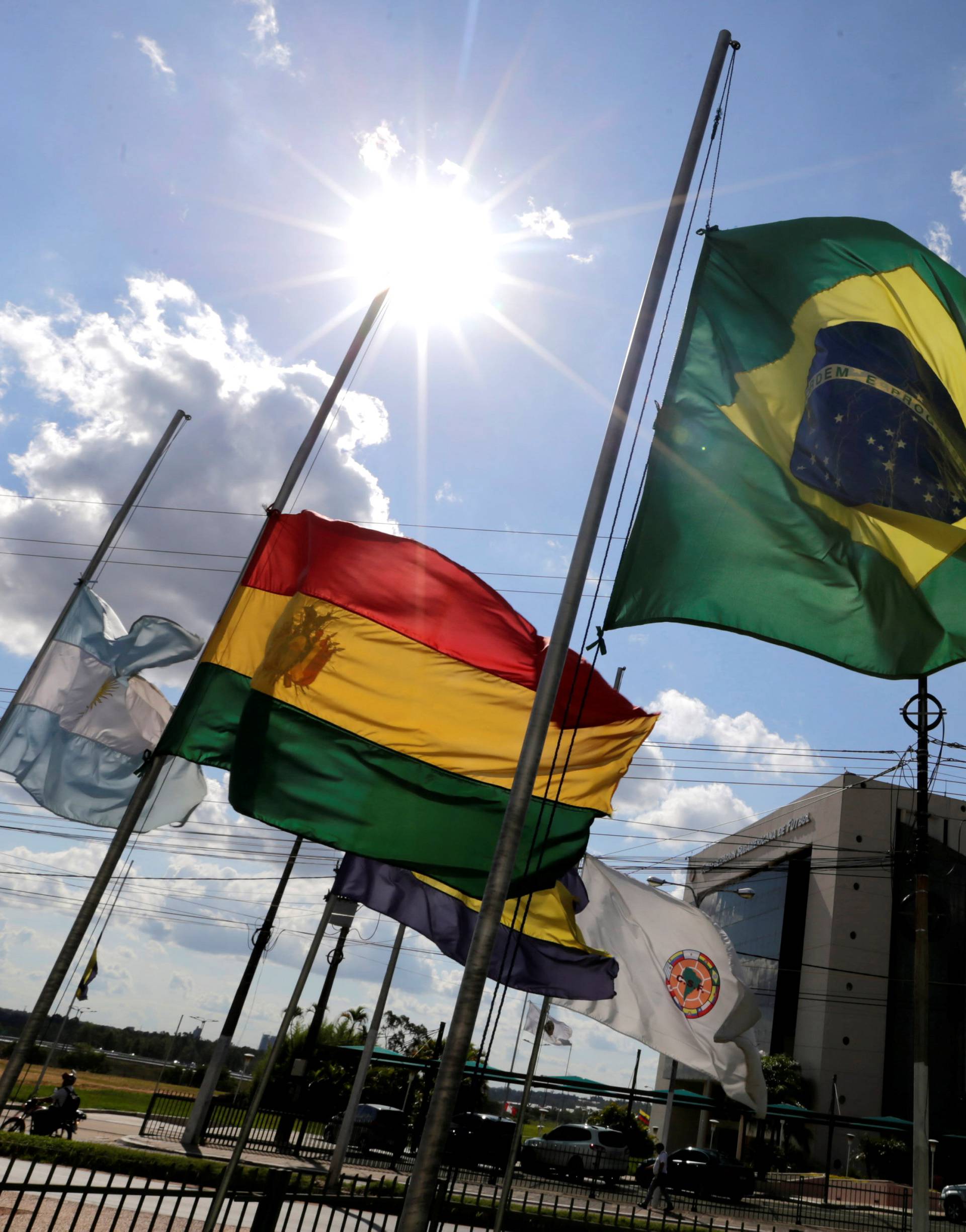 The flags of Brazil and the member countries of the CONMEBOL fly at half staff, paying tribute to members of Chapecoense soccer team in a plane crash in Colombia, in front of the headquarters in Luque