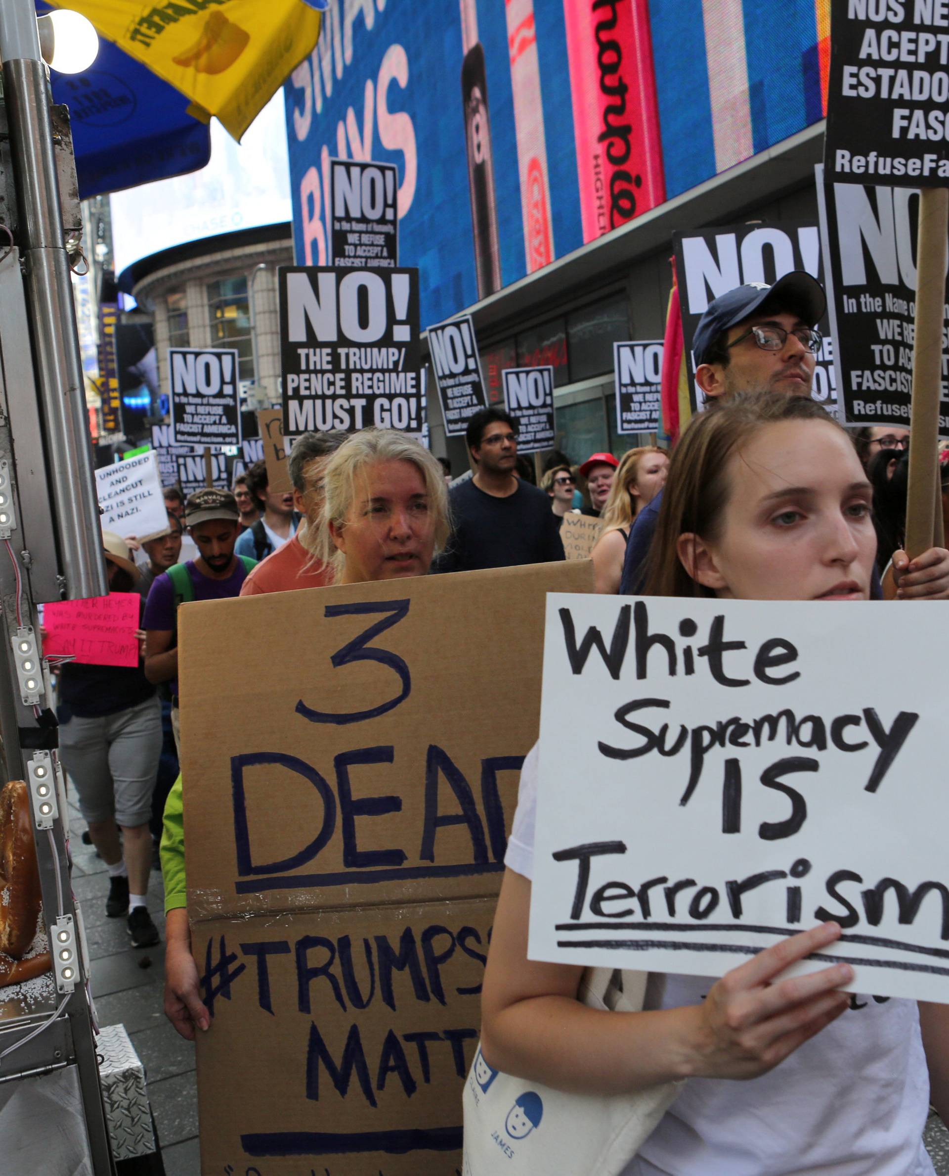 A protester holds a sign reading "White supremacy is terrorism" at a march against white nationalism in New York City