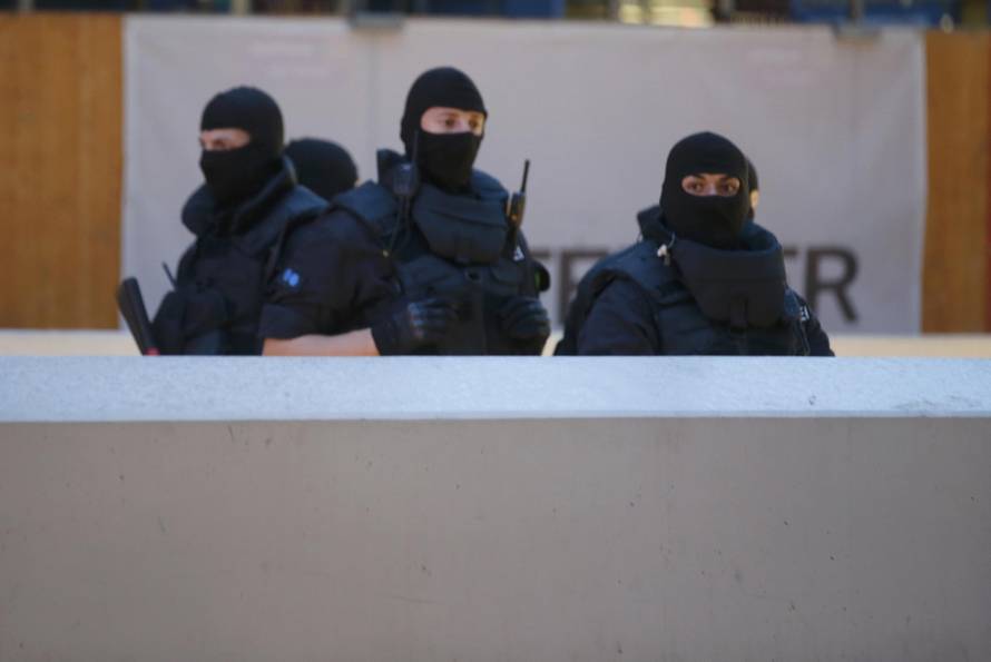 Special force police officers stand guard at entrance of main train station following shooting rampage at shopping mall in Munich