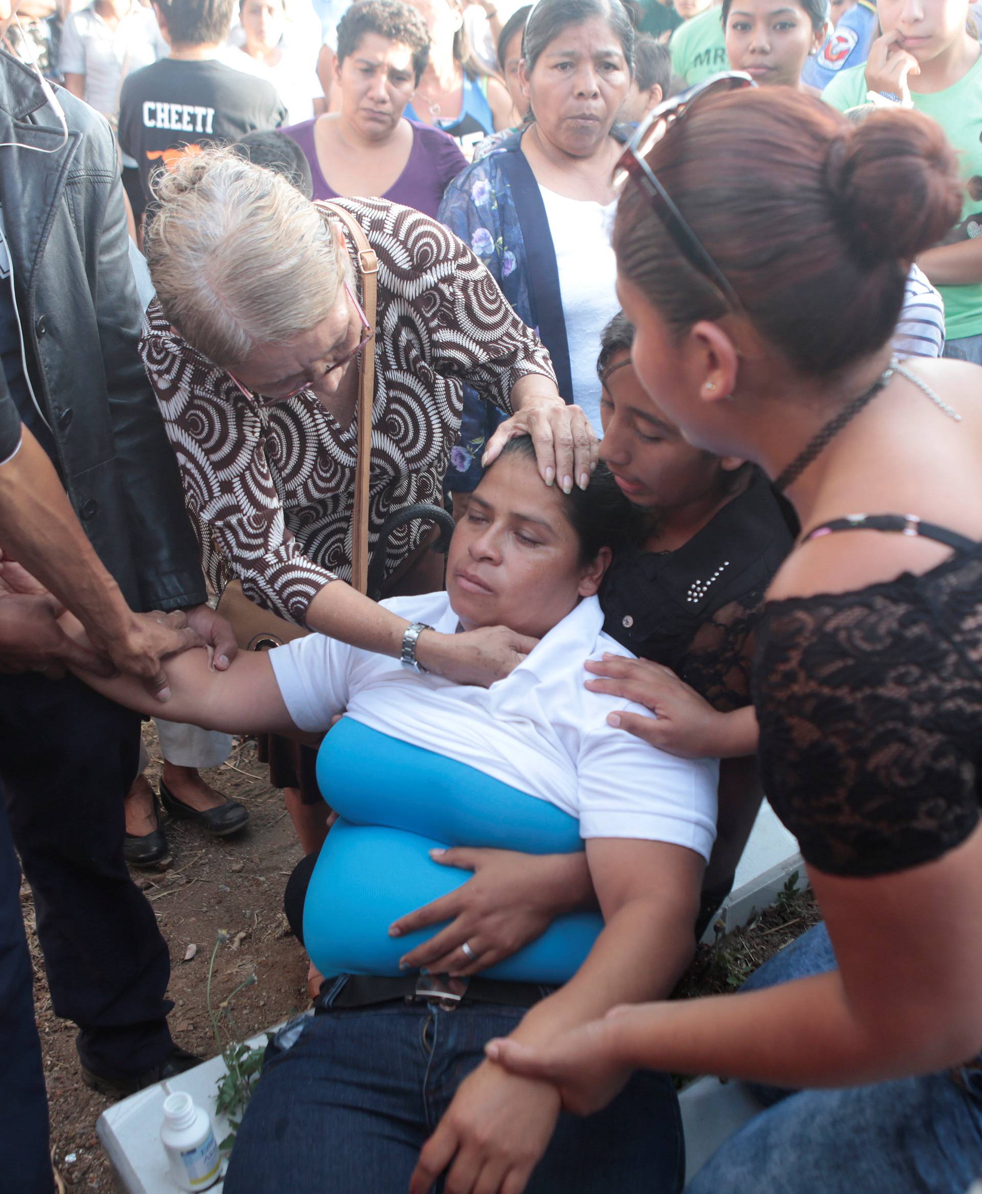 A relative reacts during the funeral of Juana Aguilar, a police officer who died from injury sustained during the protests over a reform to the pension plans of the Nicaraguan Social Security Institute, at the cemetery in Jinotepe