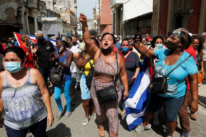 Government supporters react during protests against and in support of the government, in Havana