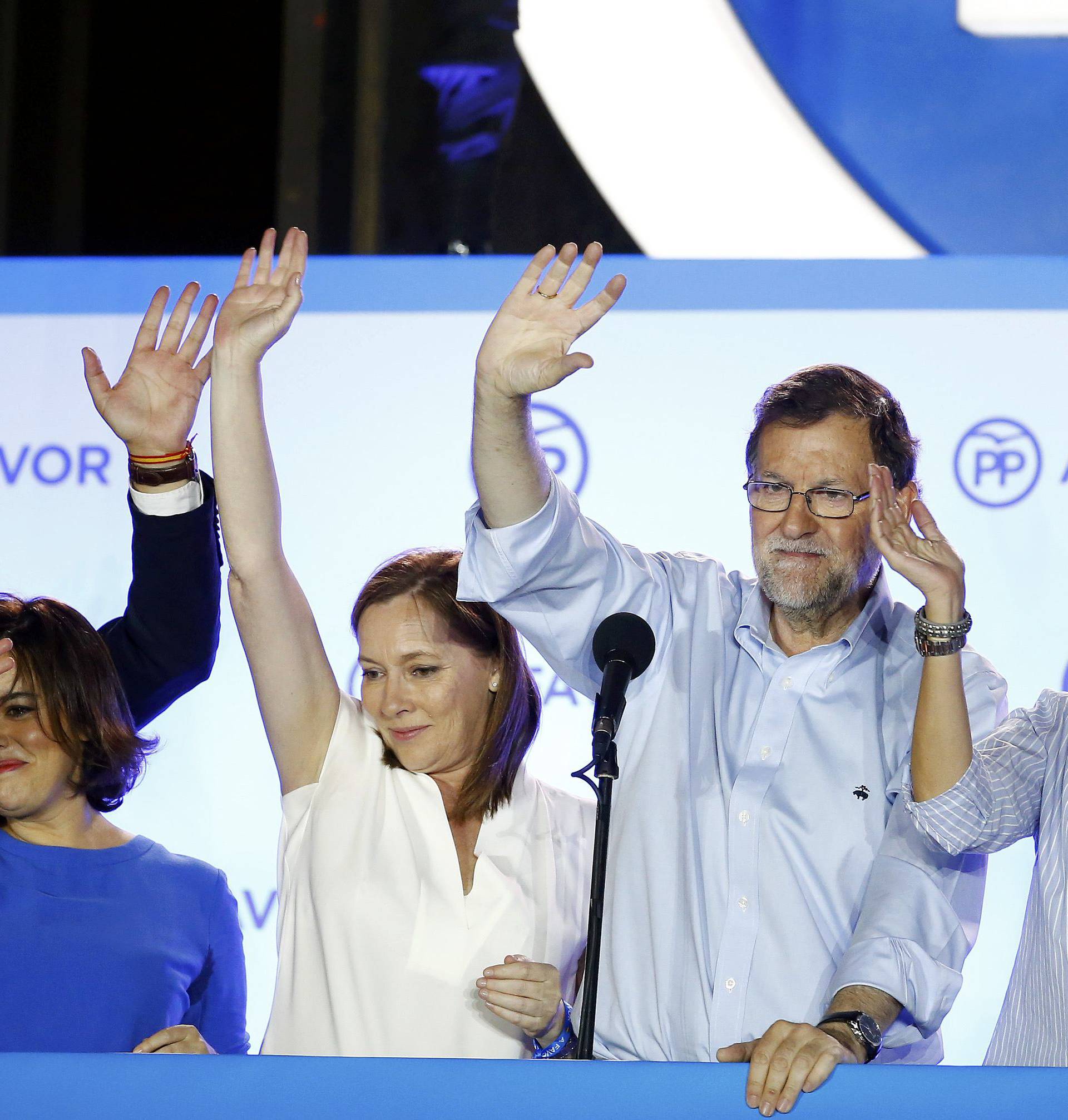 Spain's acting prime minister and People's Party (PP) leader Mariano Rajoy waves to supporters at party headquarters after Spain's general election in Madrid