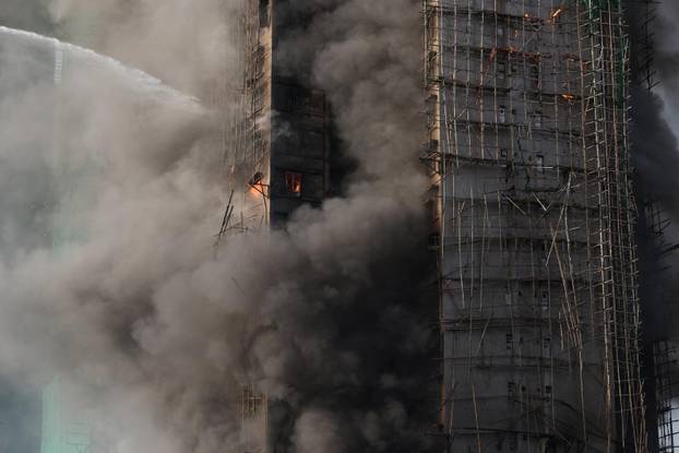 Flames engulf bamboo scaffolding across multiple buildings at Wang Fuk Court housing estate, in Tai Po