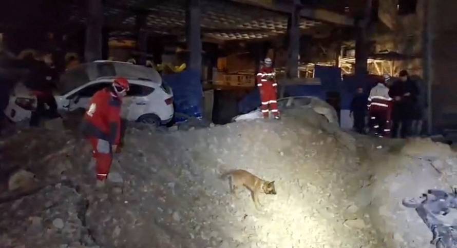 Rescue workers inspect the site of a reported strike, amid the U.S.-Israeli conflict with Iran, in Tehran