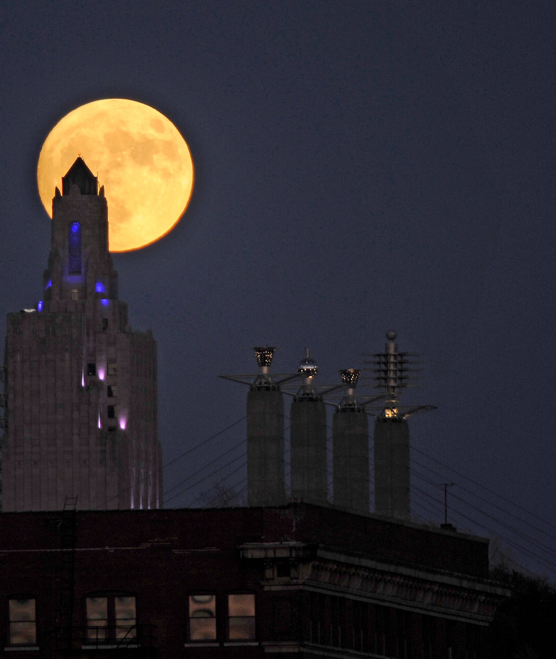 The "supermoon", the closest the moon comes to Earth since 1948, rises over the Power and Light building in downtown Kansas City, Missouri