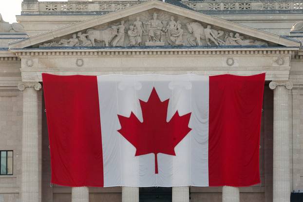 Giant Canadian flag hangs on legislative building