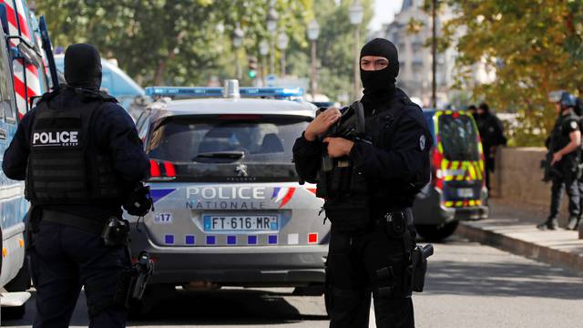 French police forces are seen near the Paris courthouse on the Ile de la Cite in Paris