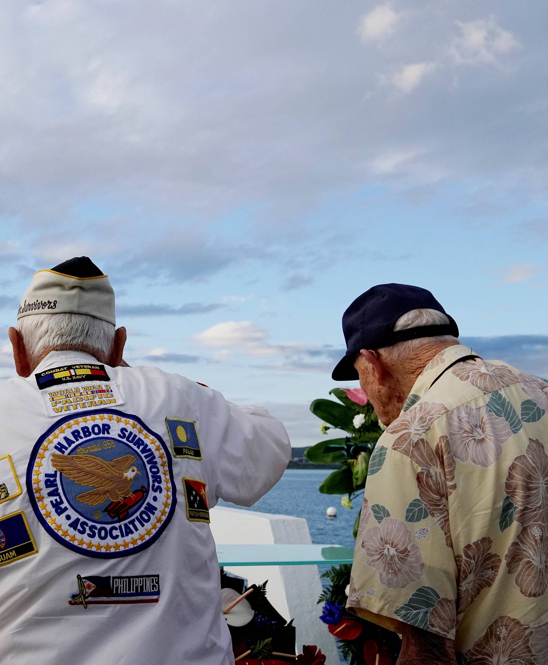 Pearl Harbor survivors Delton Walling, Gilbert Meyer and U.S. Navy Admiral Margaret Kibben salute during a ceremony honoring the sailors of the USS Utah at the memorial on Ford Island at Pearl Harbor in Honolulu, Hawaii