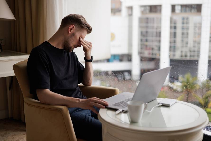 A,Tired,Businessman,Experiences,Information,Overload,,Headaches,On,Remote,Video