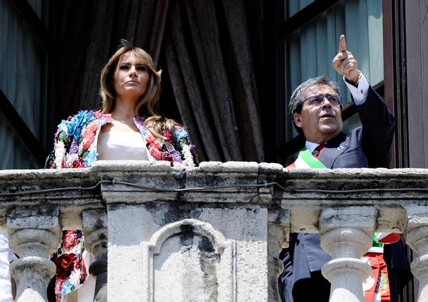 Mayor of Catania Enzo Bianco gestures next to U.S. first lady Melania Trump from the balcony of the Town Hall in Catania