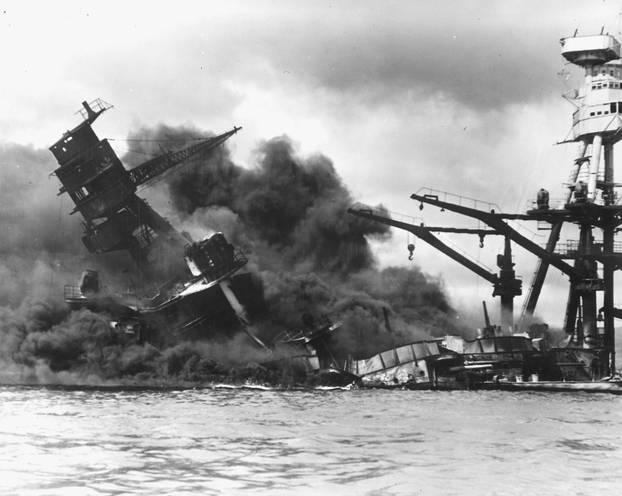 The battleship USS Arizona sinks after being hit by a Japanese air attack on Pearl Harbor