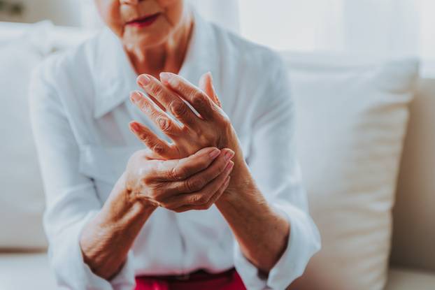 Senior lady is feeling arm ache at home