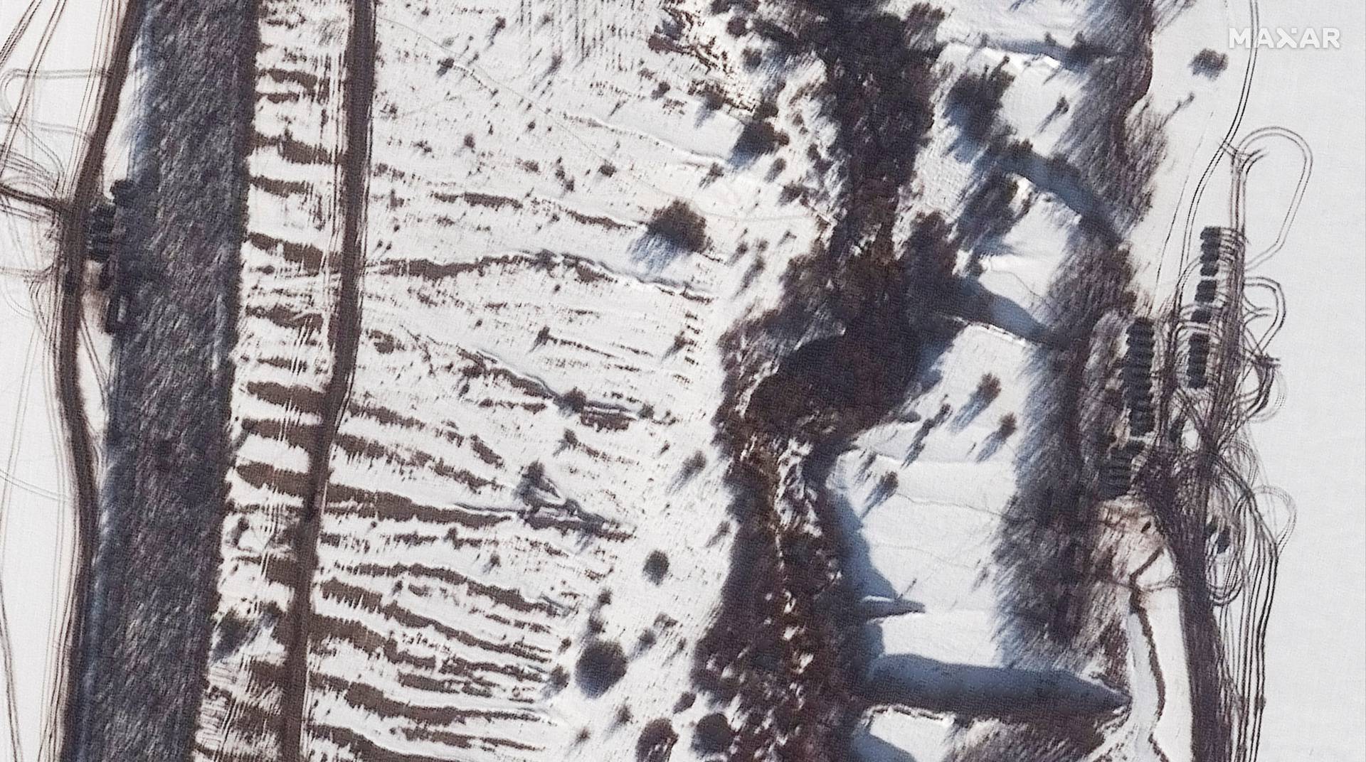 A satellite image shows additional armor and equipment deployed along a tree line, near Valuyki