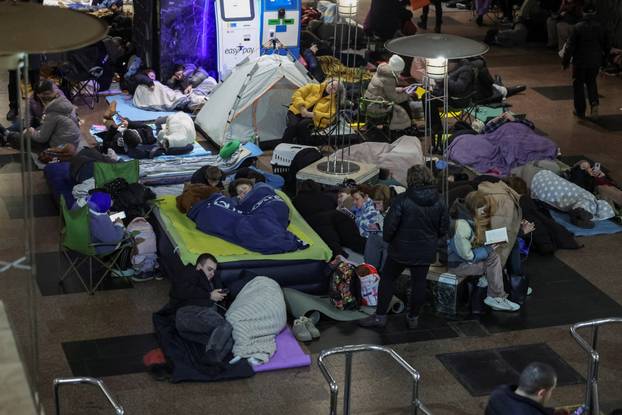 People take shelter inside a metro station during a Russian missile and drone attack in Kyiv