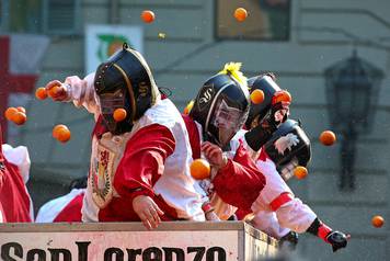 Members of rival teams fight with oranges during an annual carnival battle in the northern Italian town of Ivrea