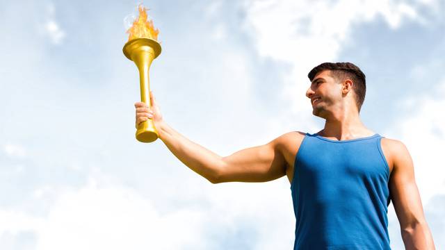 Low,Angle,View,Of,Sportsman,Holding,A,Cup,Against,Blue