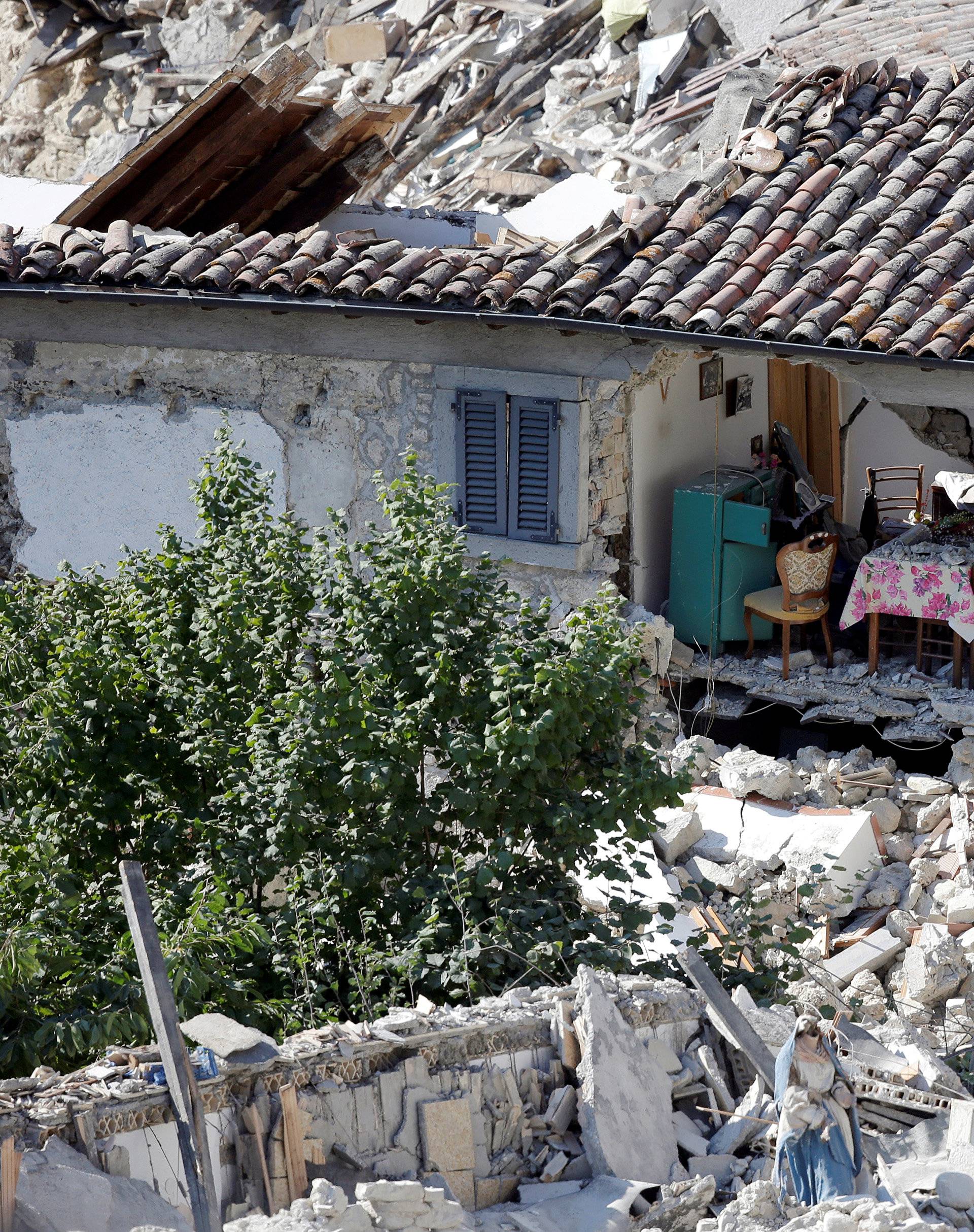 The interior of a damaged house is seen following an earthquake at Pescara del Tronto