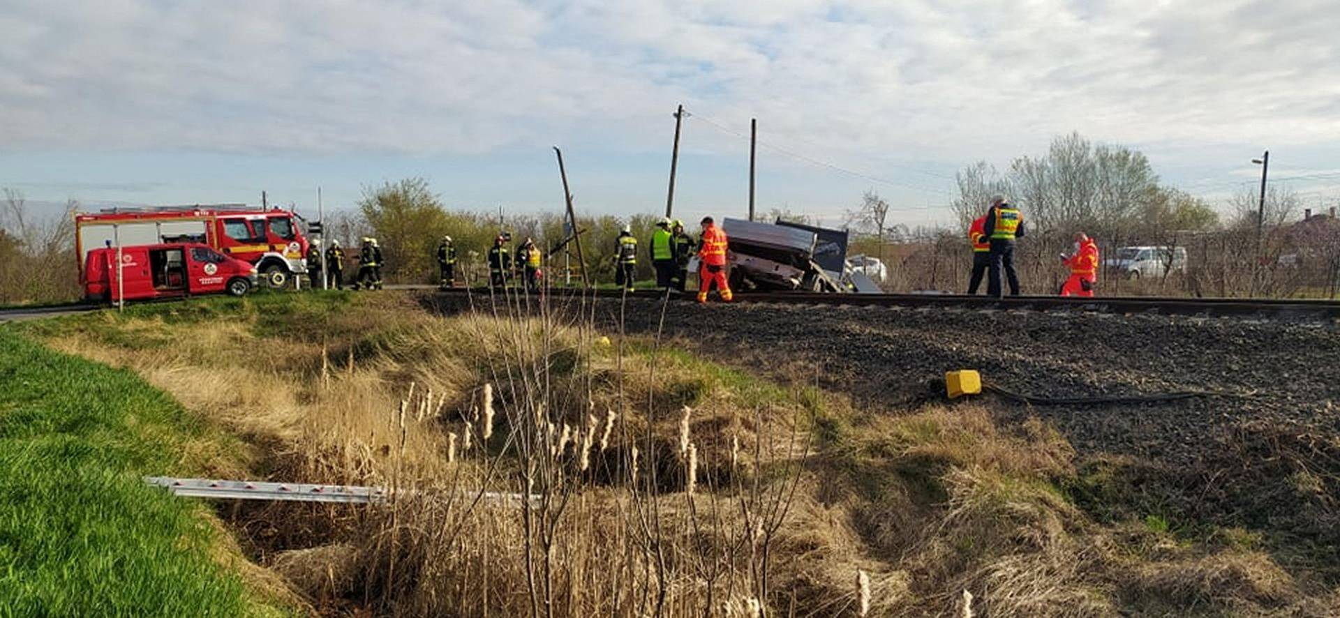 A damaged pick-up truck is seen at a scene of an accident where it crashed into a train in Mindszent