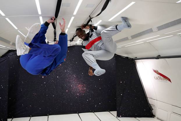 Retired sprinter Usain Bolt and French astronaut Jean-Francois Clervoy enjoy zero gravity conditions during a flight in a specially modified plane above Reims