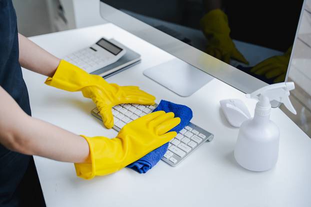 Young,Woman,Using,A,Computer,Keyboard,Cleaning,Cloth,To,Disinfect