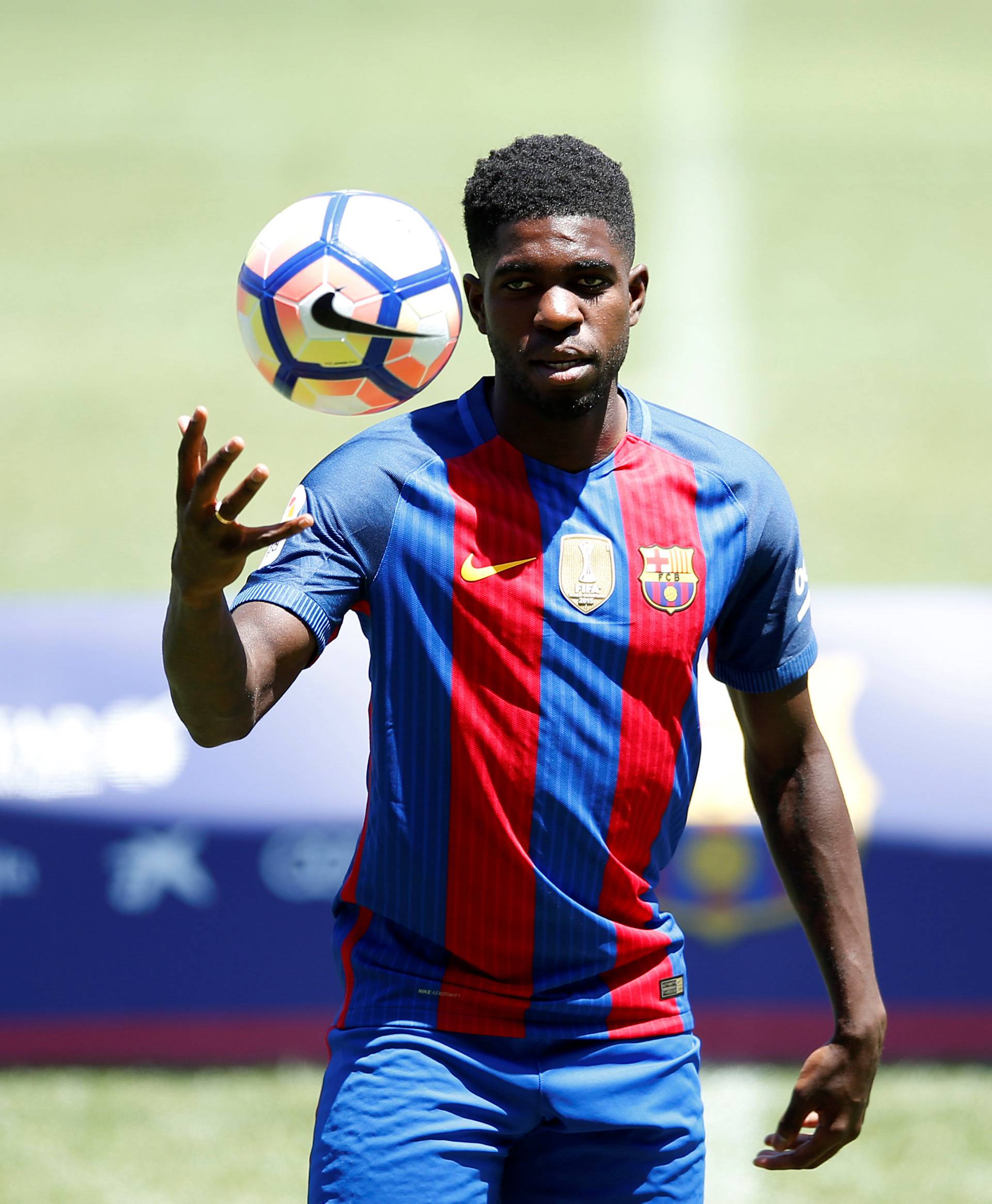 FC Barcelona's newly signed soccer player Samuel Umtiti plays wih a ball during his presentation at Camp Nou stadium in Barcelona
