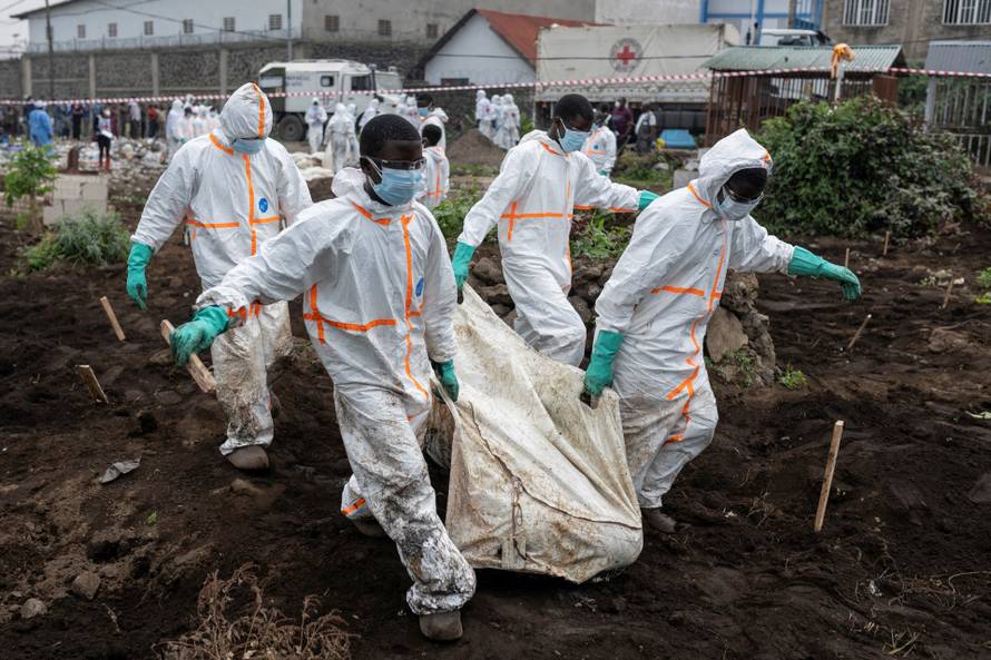 FILE PHOTO: Red Cross team members proceed with the burial of victims of the fighting, at ITIG Cemetery, in Goma