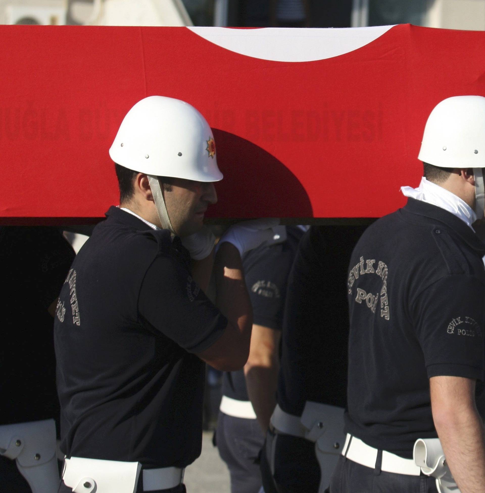 Turkish police officers carry a coffin holding the body of police officer Nedip Cengiz Eker during a funeral ceremony in Marmaris