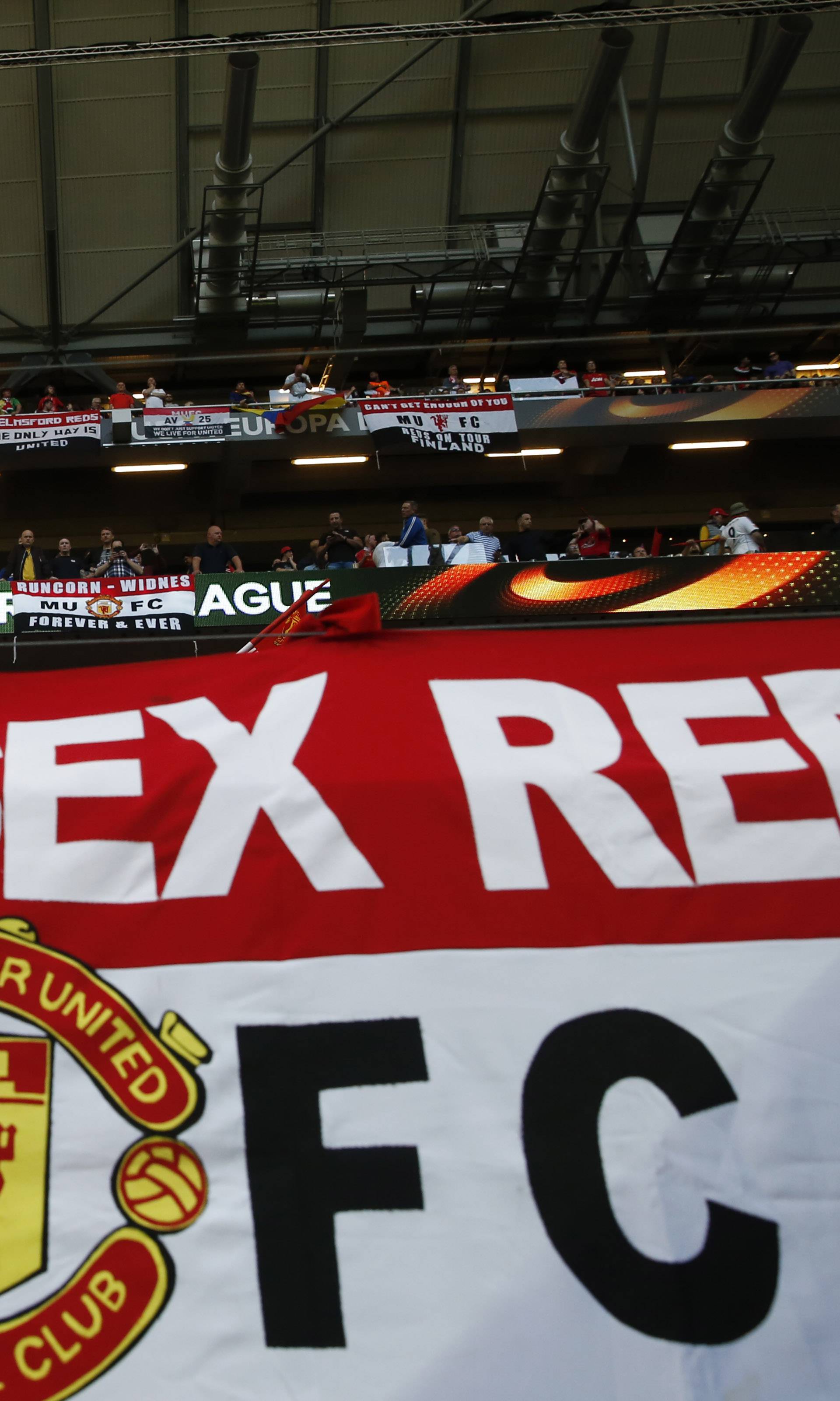 Manchester United fans with a flag inside the stadium before the match