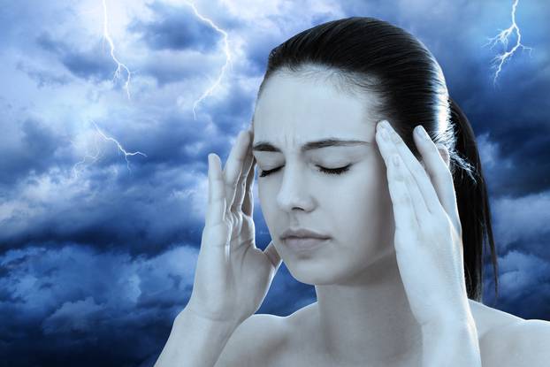 Conceptual image of woman meditating against stormy background.