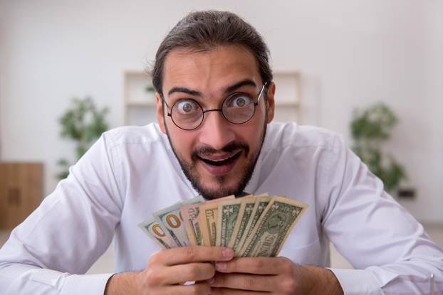 Young male bookkeeper in budget planning concept