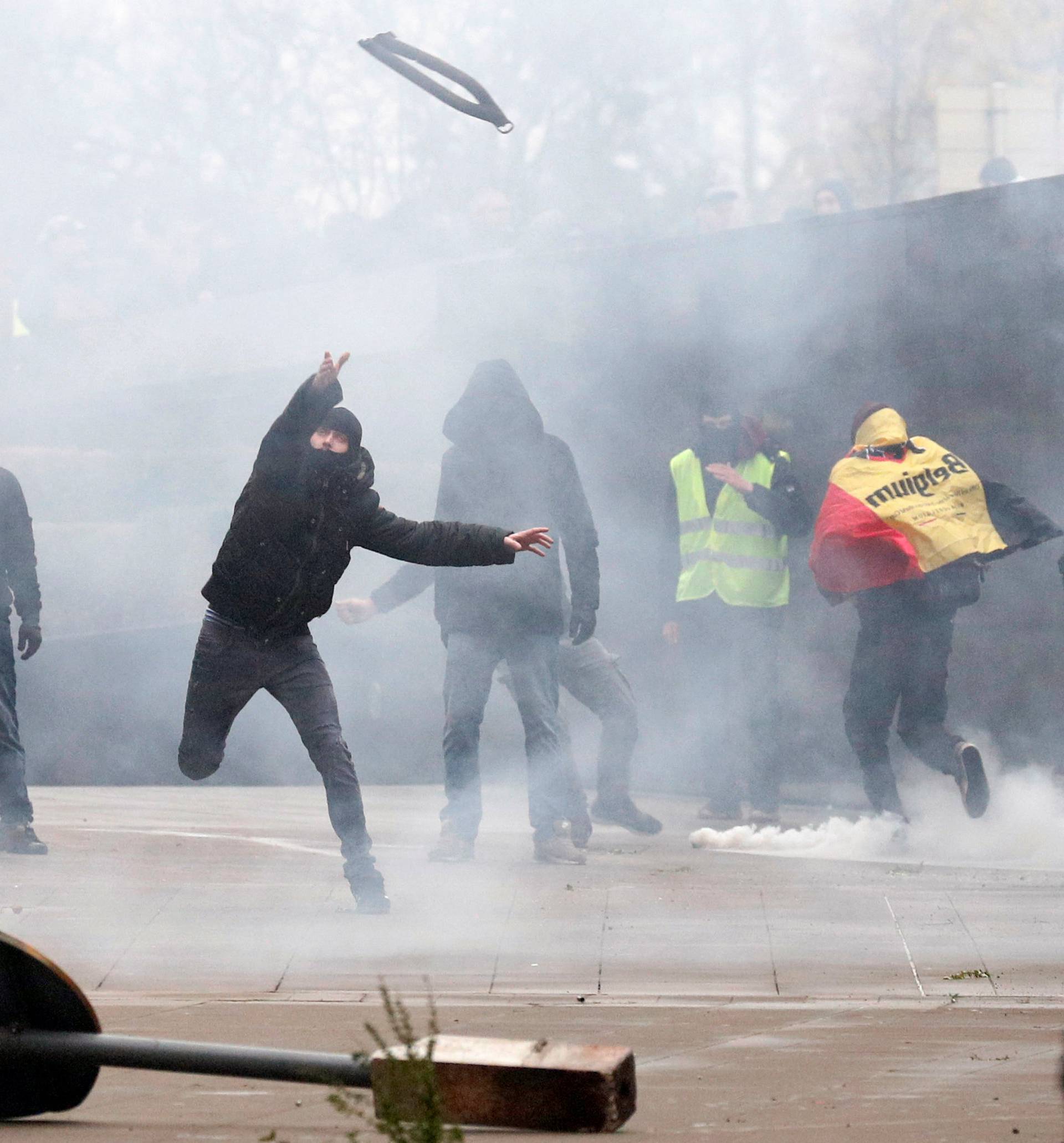 Far-right supporter throws an object during a protest against Marrakesh Migration Pact in Brussels